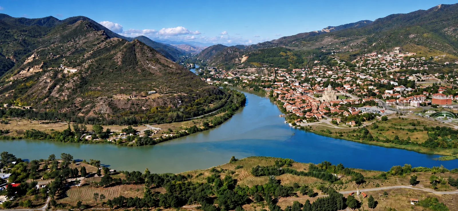The Aragvi and the Mtkvari meeting below Mtskheta, in clear daylight, the two currents holding their own color in one riverbed.